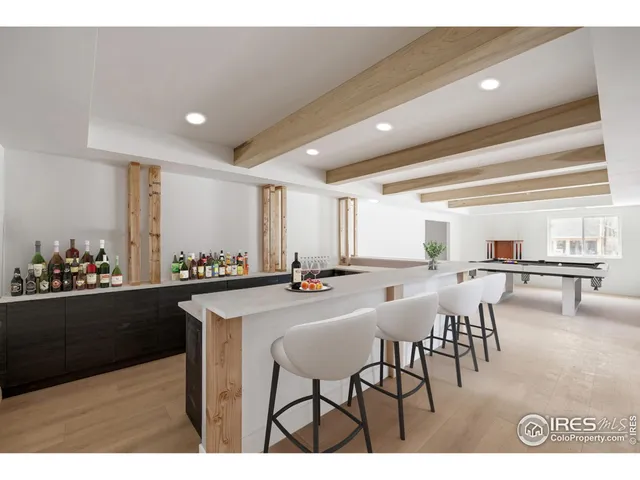 a kitchen with stainless steel appliances granite countertop a table and chairs