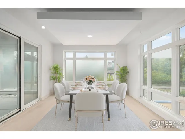a dining room with furniture and wooden floor