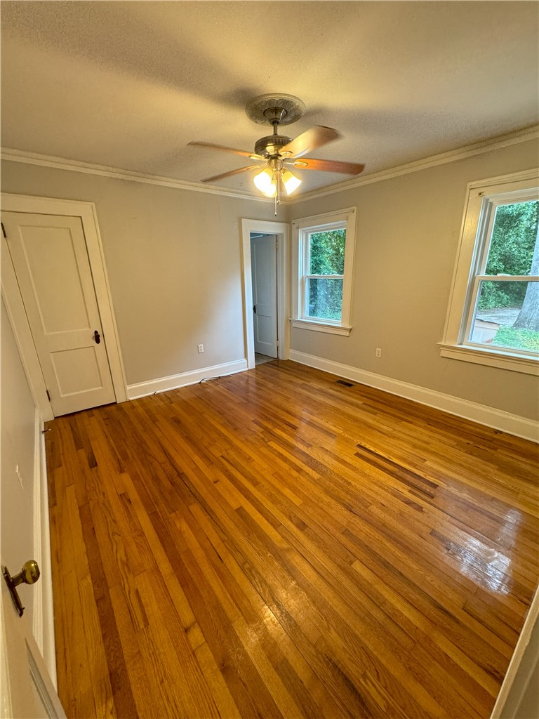 212 Whitehall Road Anderson, SC 29625 - Photo 8 of 12 Polished hardwood floors and classic crown molding define this versatile living space.