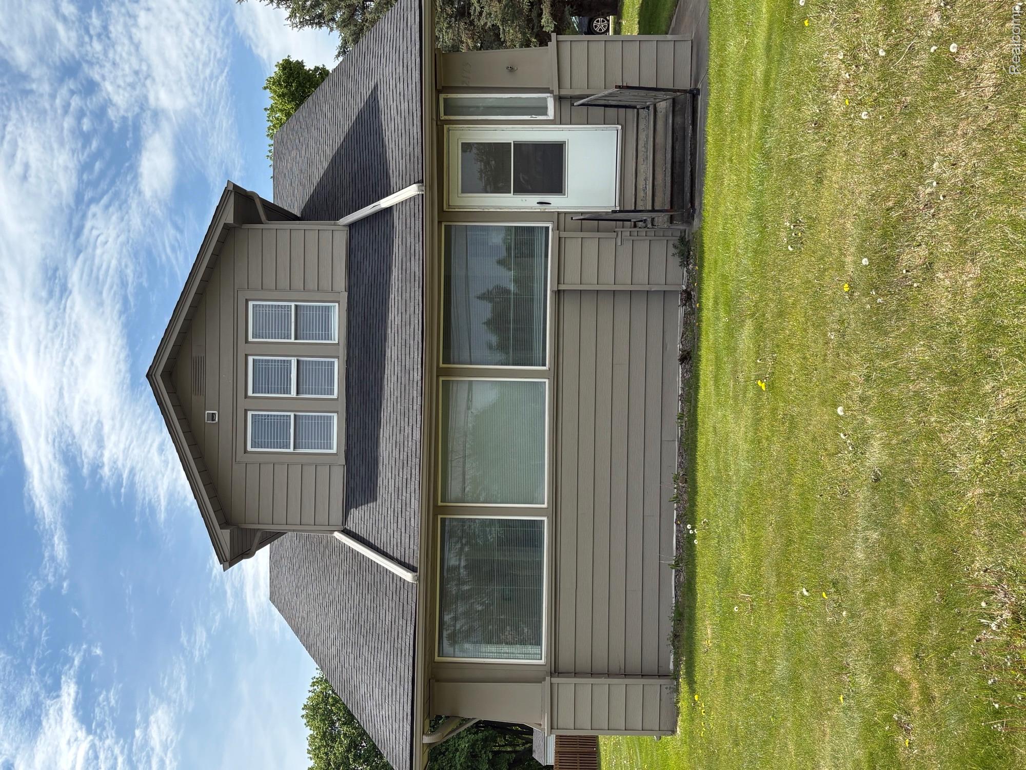2175 West Auburn Road Rochester, MI 48309 - Photo 1 of 30 View of front facade featuring a front lawn, a shingled roof, and entry steps