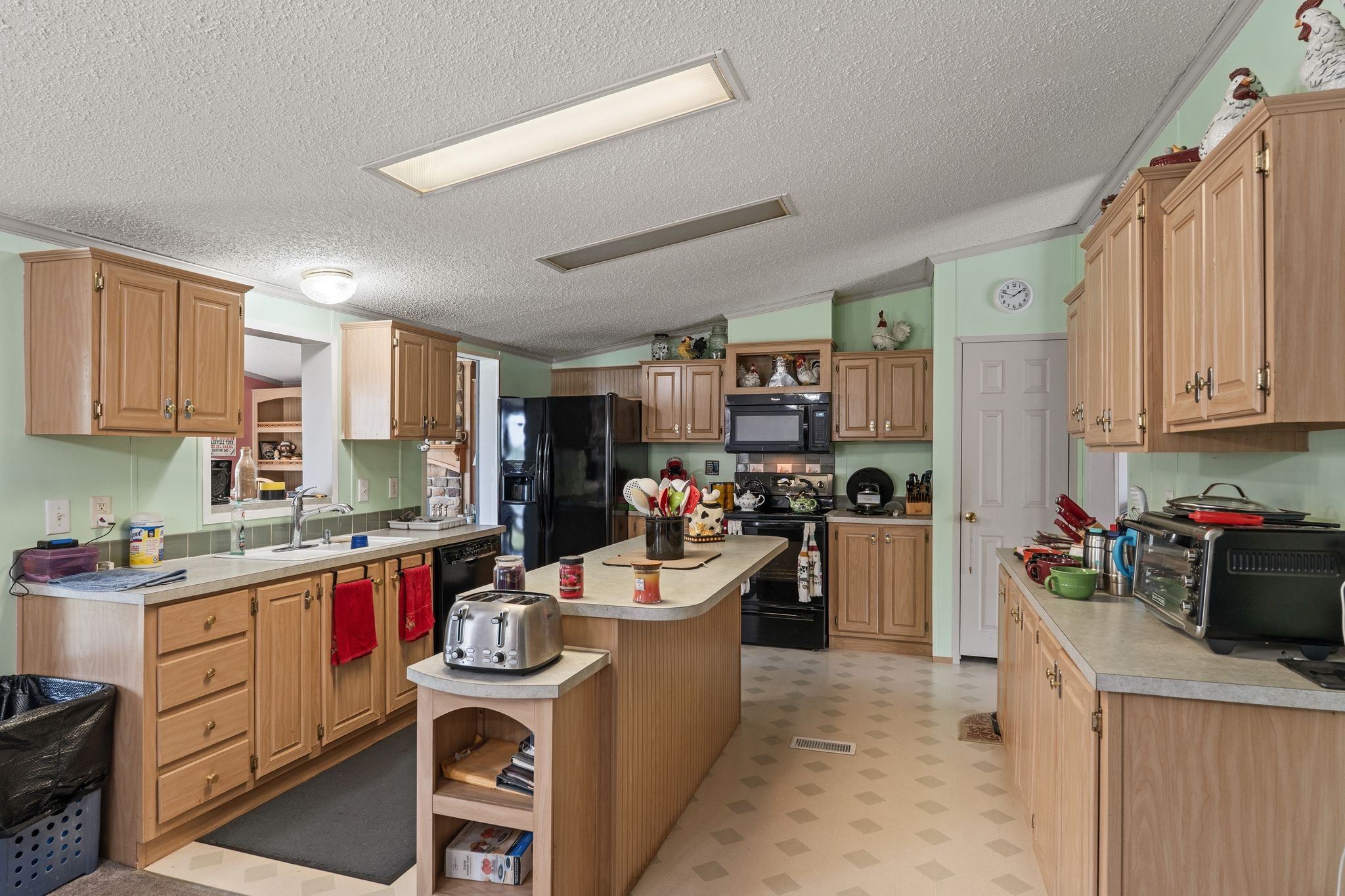 2636 Balthrop Road Pleasant View, TN 37146 - Photo 12 of 63 a kitchen with stainless steel appliances kitchen island granite countertop a stove a sink dishwasher and a refrigerator with wooden cabinets