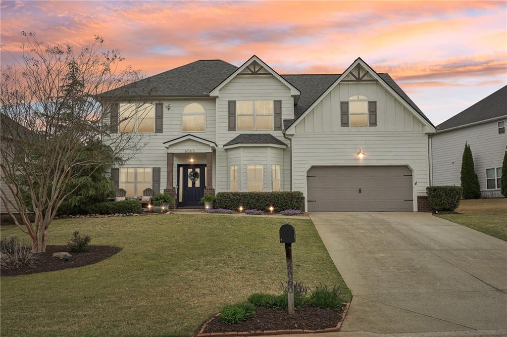 6060 Country Lake Road Cumming, GA 30041 - Photo 1 of 1 a front view of a house with a yard