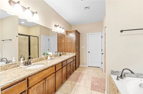a bathroom with a double vanity sink and a mirror