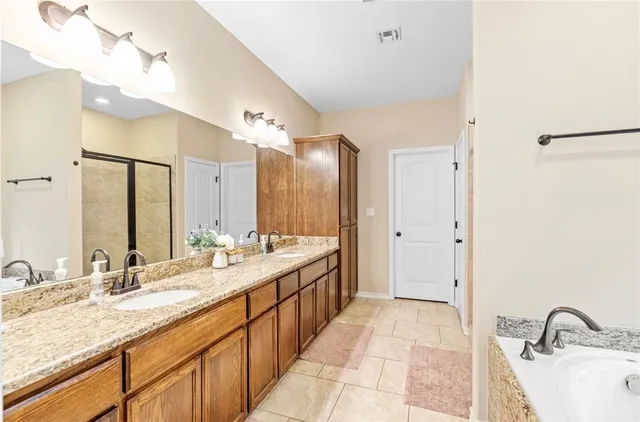 a bathroom with a double vanity sink and a mirror