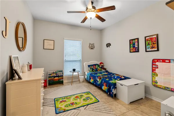 a children room with toys and a chandelier