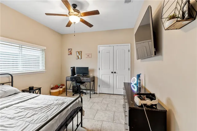 a bedroom with a bed and a window