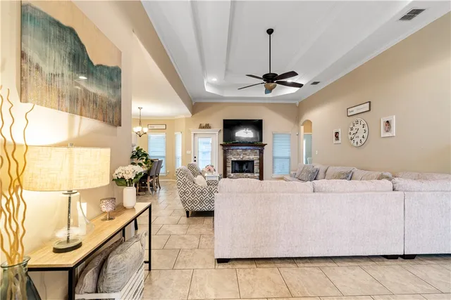 a living room with furniture a chandelier and a flat screen tv