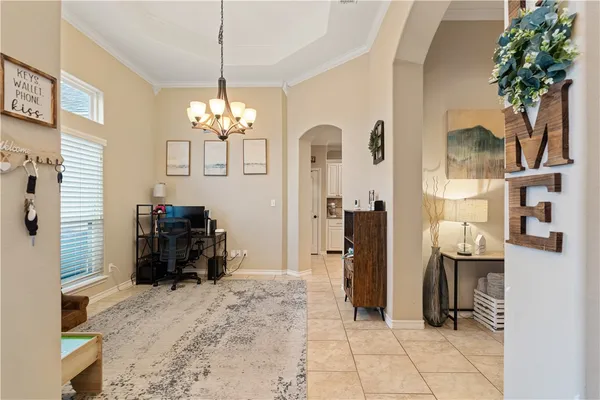 a living room with fireplace furniture and a chandelier