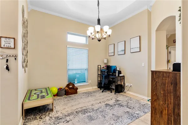 a bedroom with furniture and a chandelier