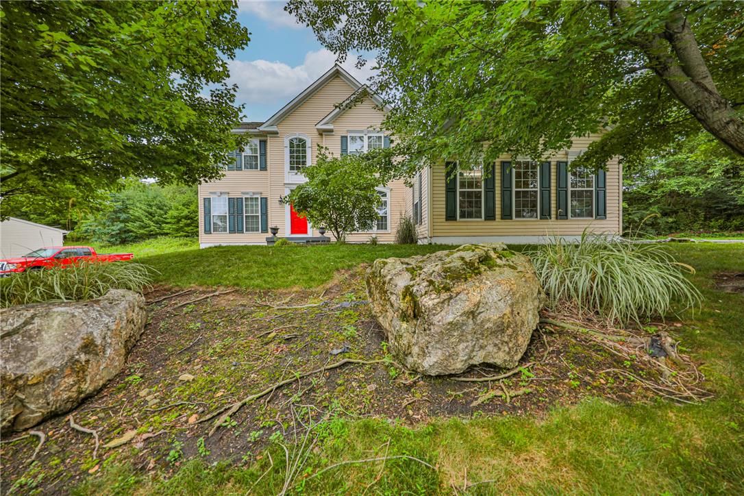 138 Clover Hollow Road Easton, PA 18045 - Photo 2 of 95 A classic two-story residence with a striking red door and verdant landscaping.