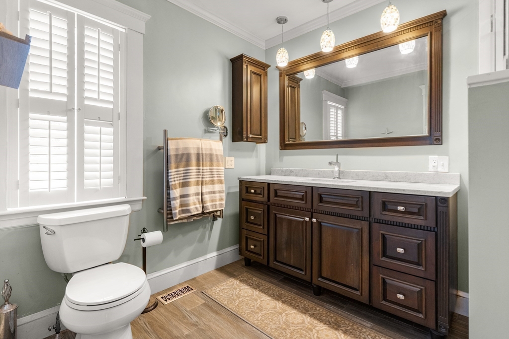 34 Decatur Street Gloucester, MA 01930 - Photo 16 of 31 a bathroom with a toilet a sink and mirror