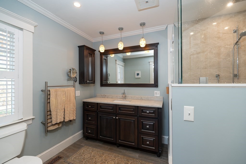 34 Decatur Street Gloucester, MA 01930 - Photo 17 of 31 a bathroom with a sink double vanity and a mirror
