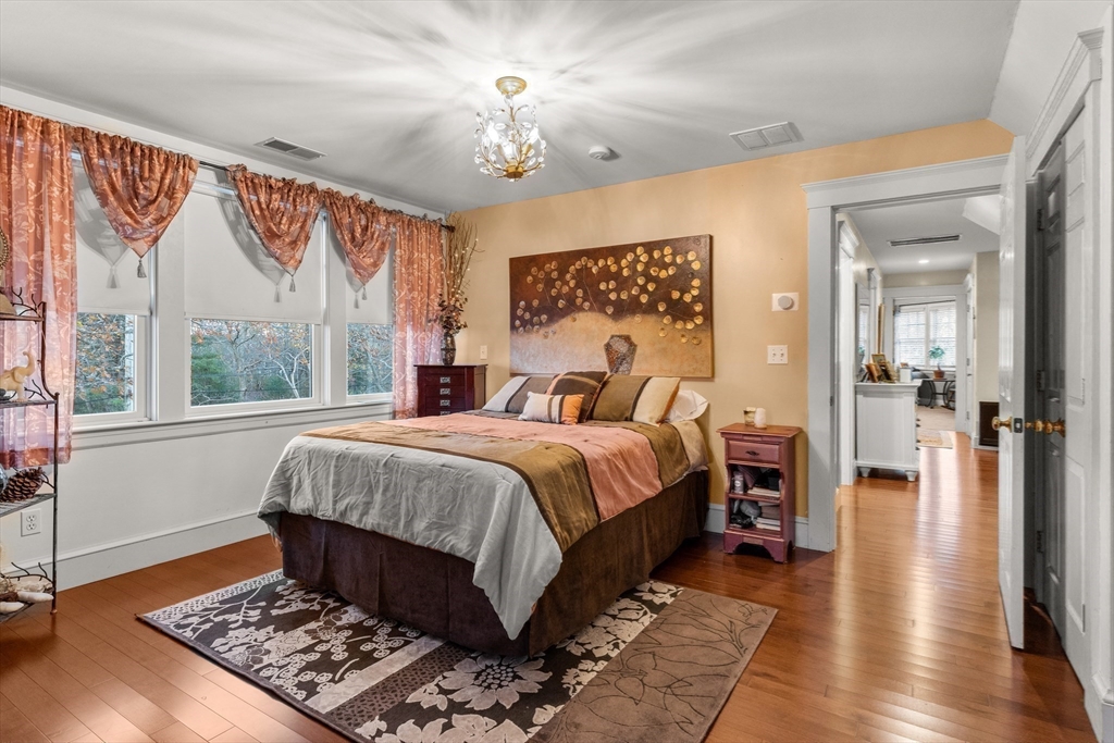 34 Decatur Street Gloucester, MA 01930 - Photo 18 of 31 a bedroom with a large bed and a chandelier