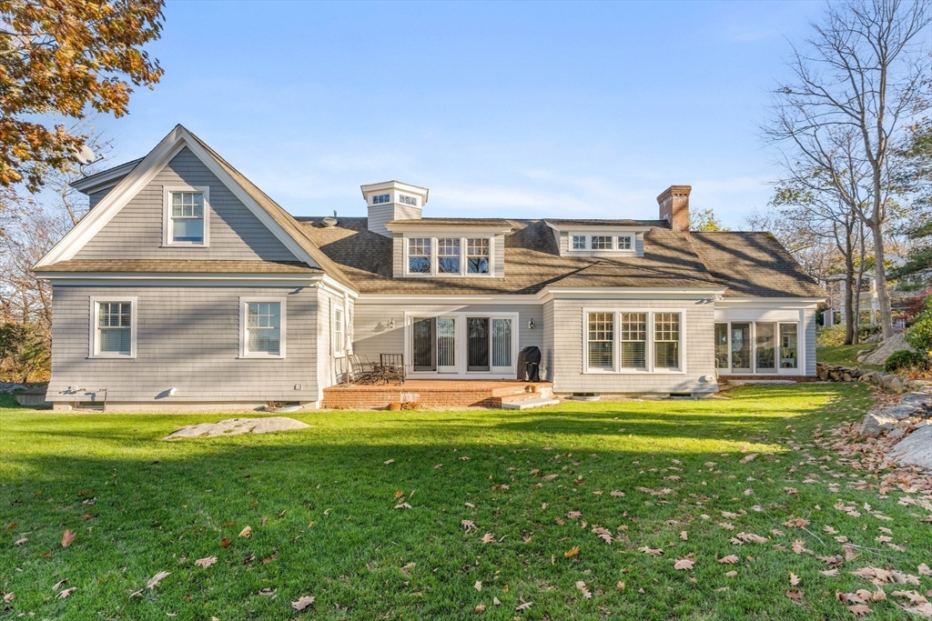 34 Decatur Street Gloucester, MA 01930 - Photo 4 of 31 a front view of a house with a garden and trees