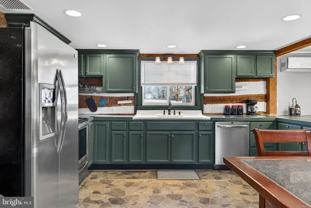 a kitchen with stainless steel appliances granite countertop a stove refrigerator and microwave