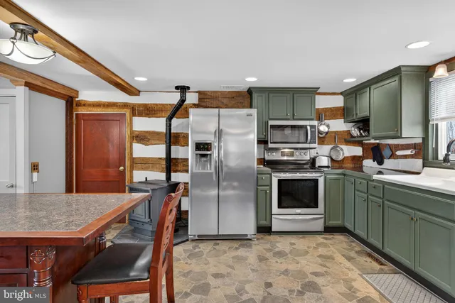 a kitchen with stainless steel appliances granite countertop a sink and cabinets