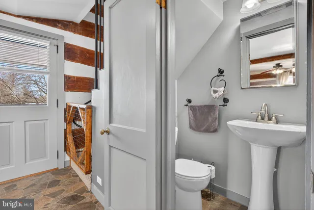 a view of a livingroom with wooden floor and staircase