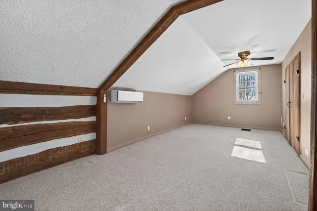 a view of room with stairs and a ceiling fan