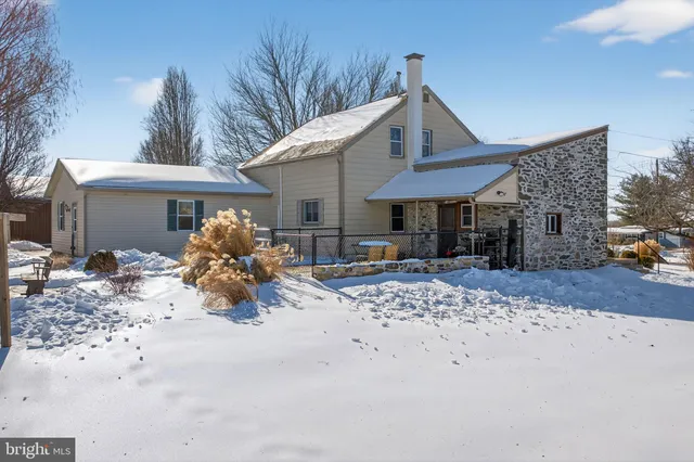 a front view of a house with a yard outdoor seating and barbeque oven