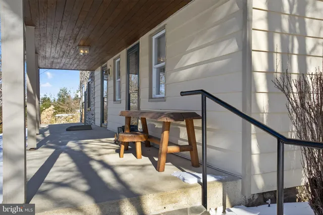 a room with a large window and furniture