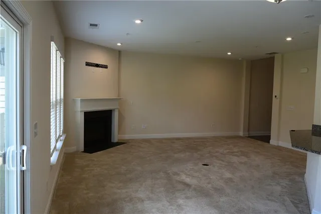 a kitchen with granite countertop a sink and a window