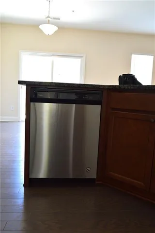 a kitchen with a refrigerator and ceiling fan