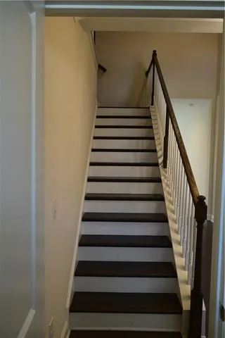 a white toilet sitting in a bathroom next to a window