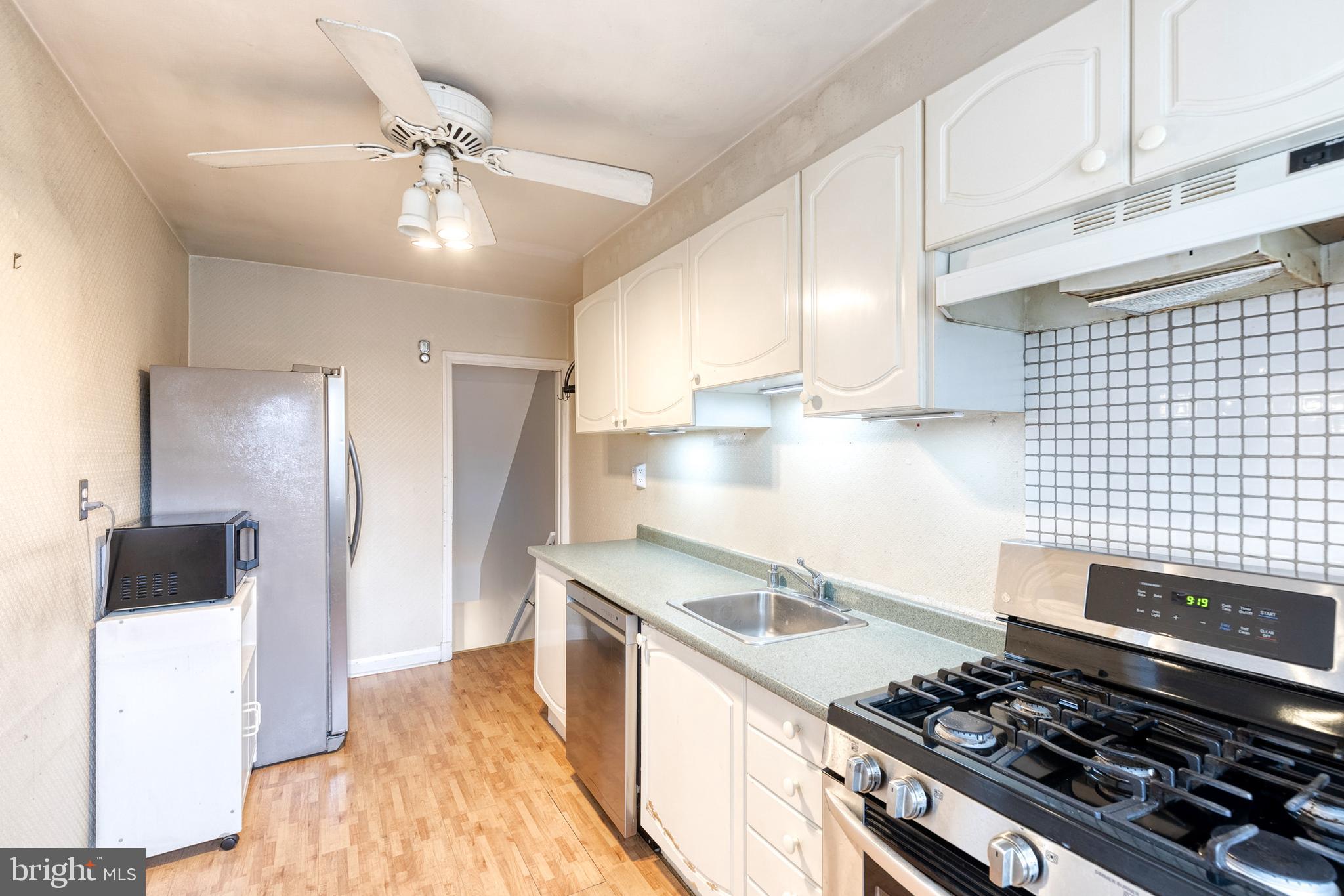 122 Regester Avenue Baltimore, MD 21212 - Photo 15 of 36 a kitchen with a stove and a refrigerator