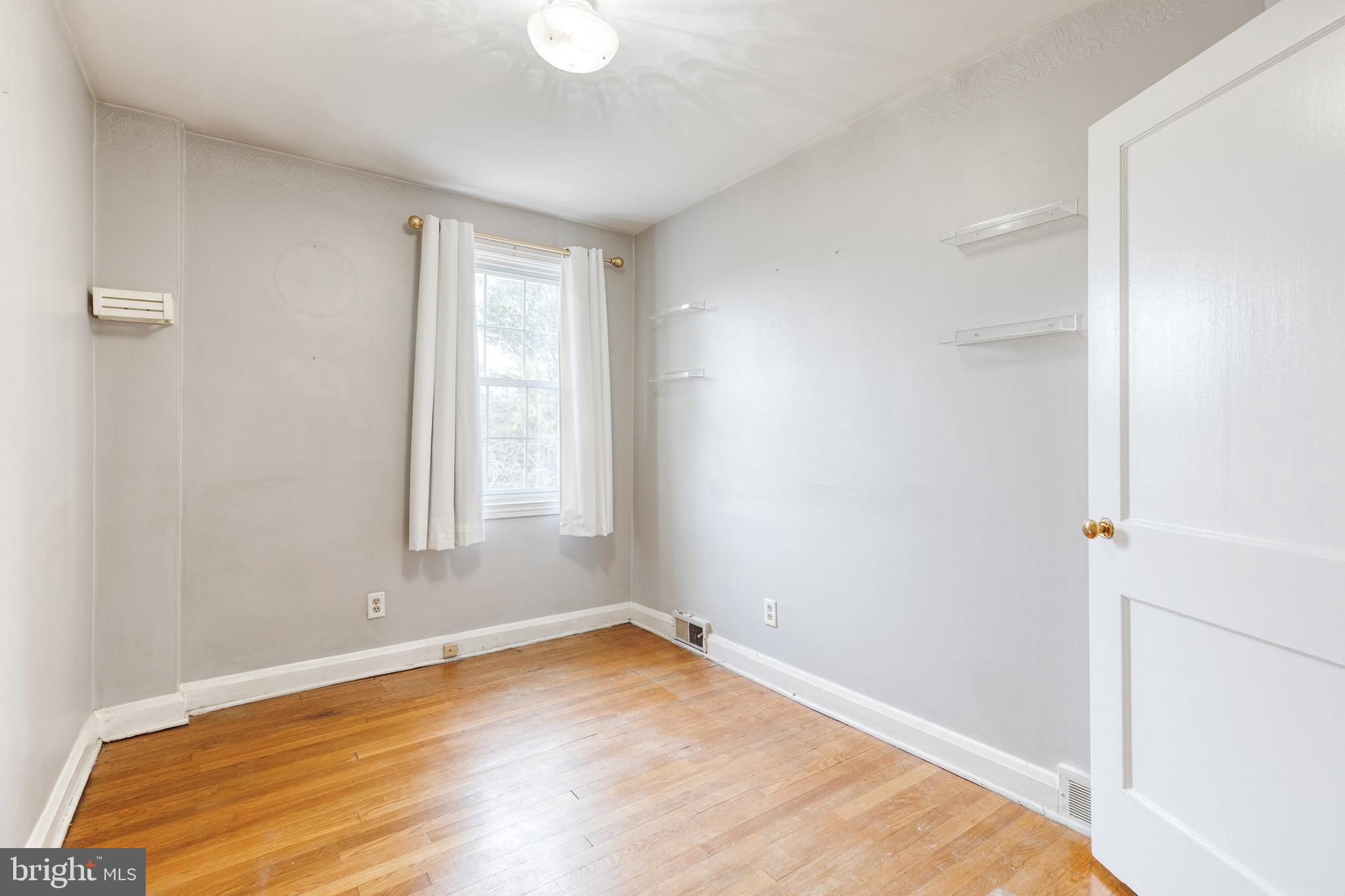 122 Regester Avenue Baltimore, MD 21212 - Photo 19 of 36 a view of empty room with wooden floor and fan