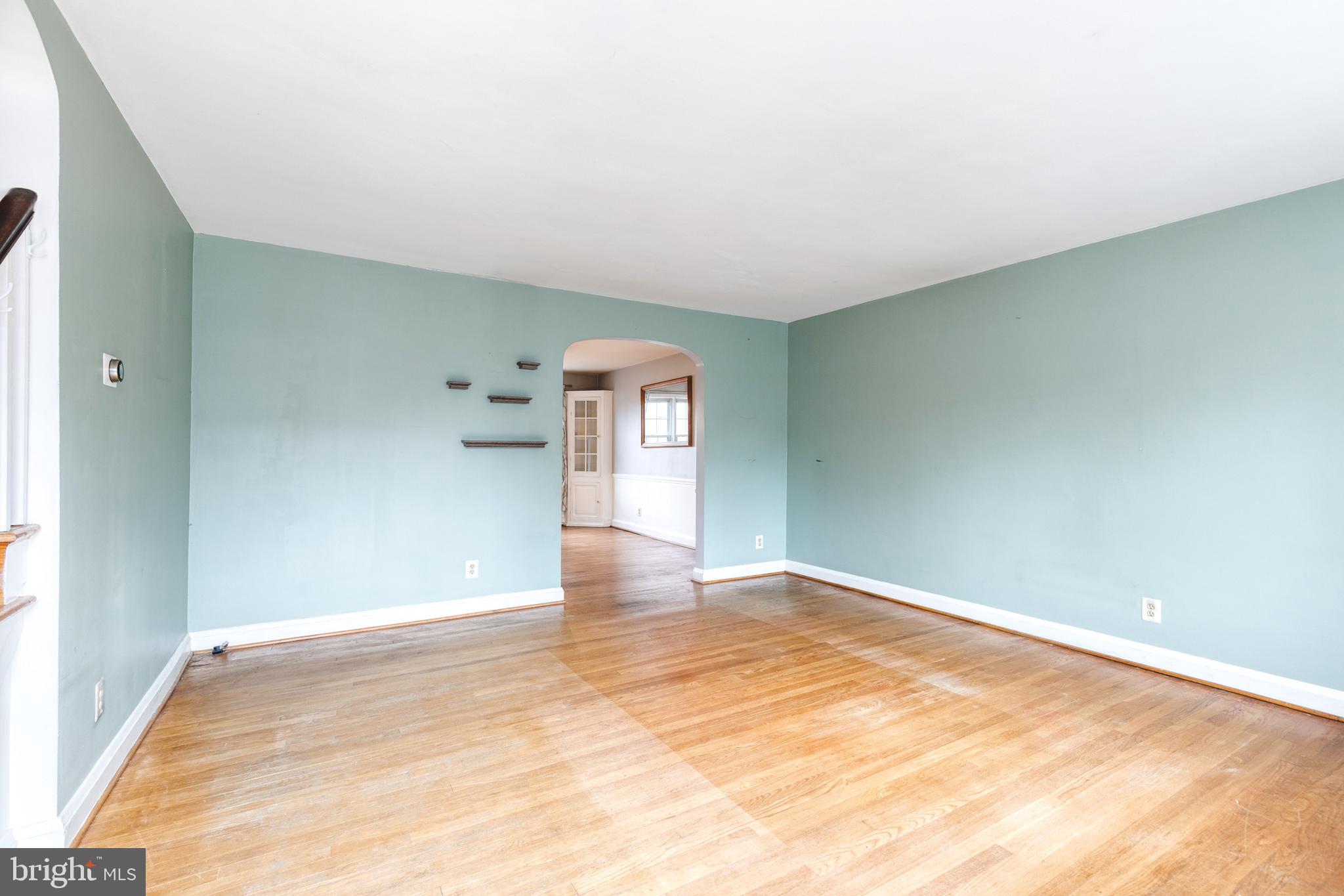 122 Regester Avenue Baltimore, MD 21212 - Photo 6 of 36 a view of empty room with wooden floor and fan
