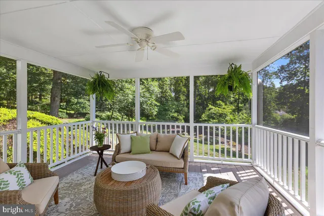 a balcony with furniture and a potted plant