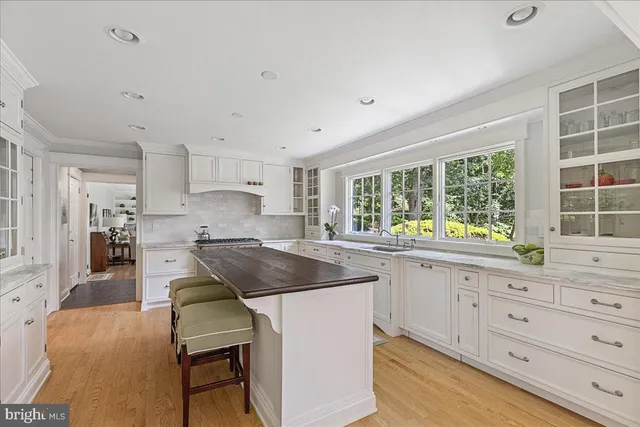 a kitchen with granite countertop white cabinets and refrigerator
