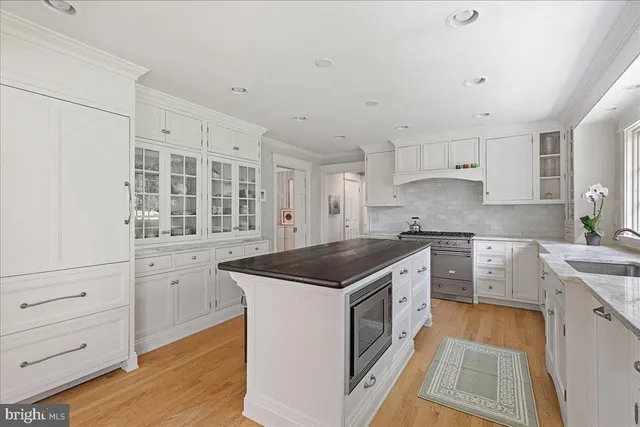a kitchen with granite countertop a sink stove and cabinets