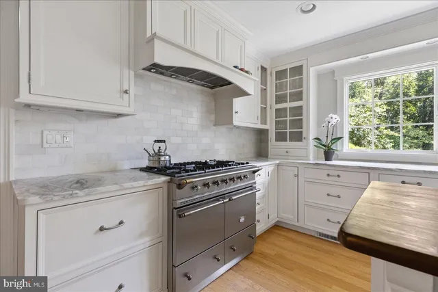 a kitchen with white cabinets and appliances