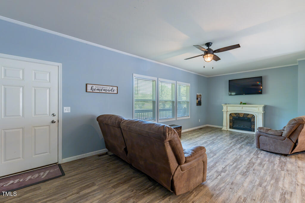 5912 Mt Zion Road Snow Camp, NC 27349 - Photo 11 of 33 a living room with furniture a fireplace and a flat screen tv