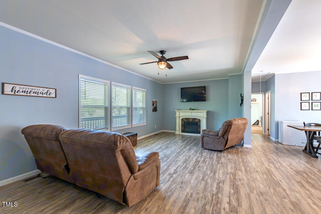 5912 Mt Zion Road Snow Camp, NC 27349 - Photo 12 of 33 a living room with fireplace furniture and a wooden floor
