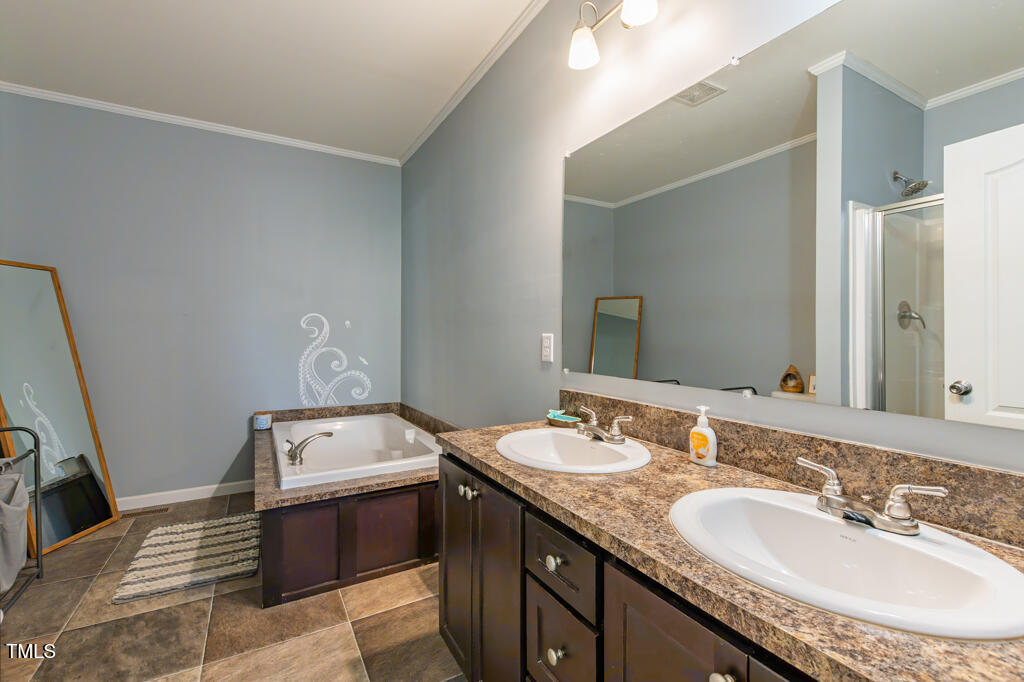 5912 Mt Zion Road Snow Camp, NC 27349 - Photo 22 of 33 a bathroom with a granite countertop sink a mirror and a