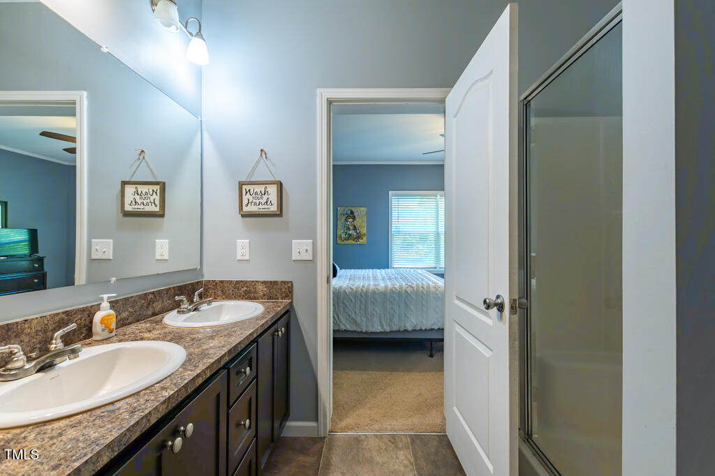 5912 Mt Zion Road Snow Camp, NC 27349 - Photo 24 of 33 a en suite bathroom with a double vanity sink and a mirror