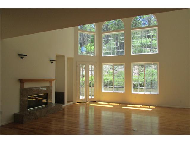 775 East Incense Cedar Road Julian, CA 92036 - Photo 2 of 25 French doors onto back patio. Wood floor. Granite faced fireplace. Open beam vaulted ceiling.