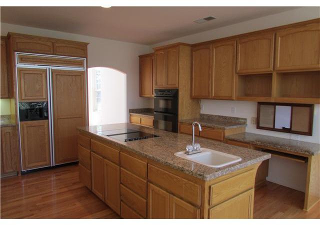 775 East Incense Cedar Road Julian, CA 92036 - Photo 5 of 25 Granite counter tops. Pull out drawers. Center island with sink and Jennair electric stove. Built in desk area. Dishwasher. Trash compactor. Wood faced refrigerator. Under cabinet lighting. Recessed lighting on ceiling. Wood floor.