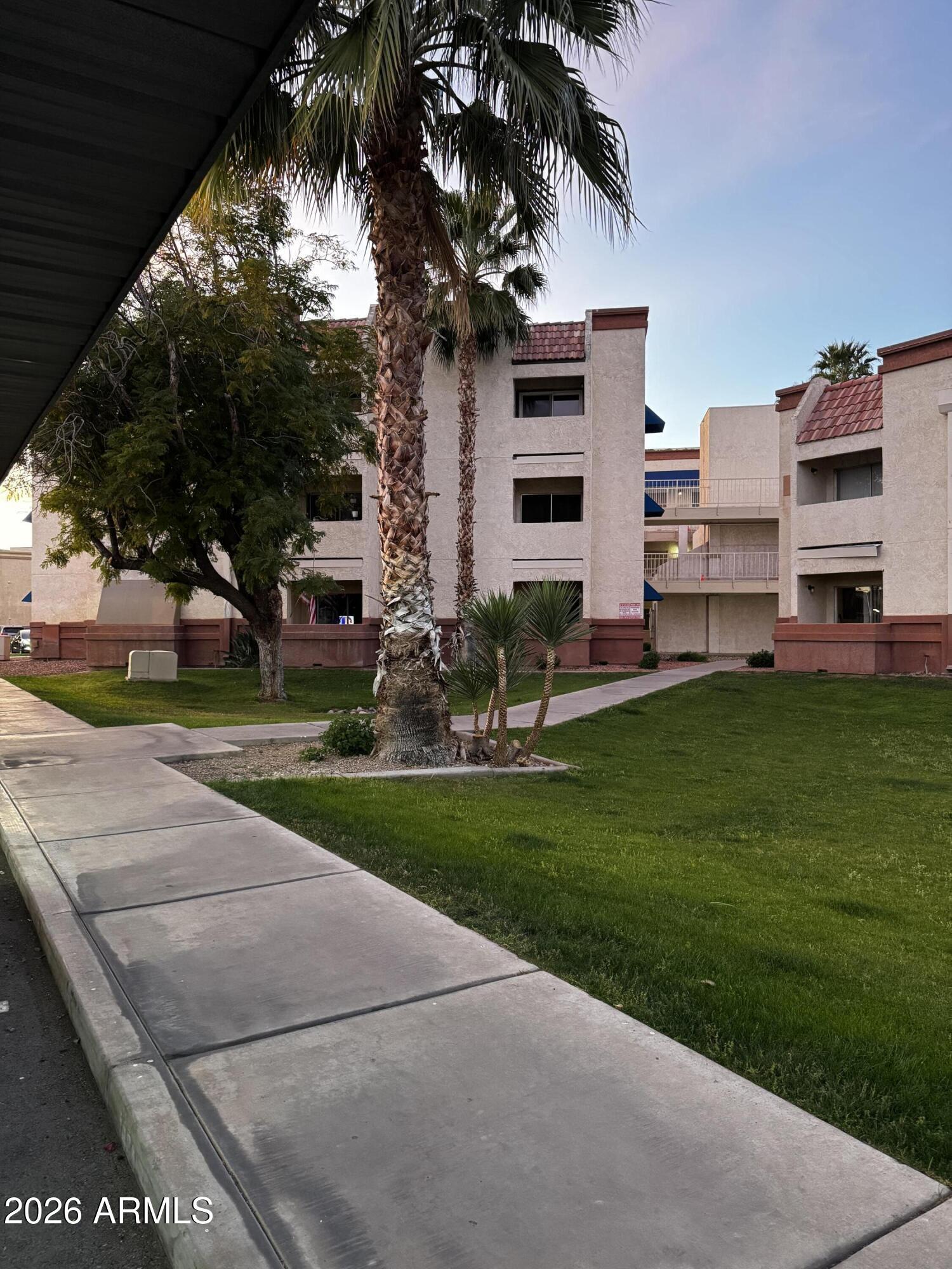 12123 West Bell Road, Unit 258 Surprise, AZ 85378 - Photo 25 of 30 a view of a house with a yard