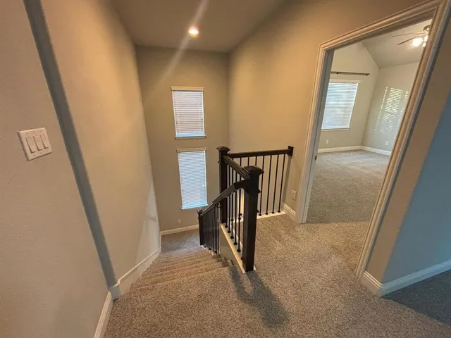 an empty room with closet and a ceiling fan