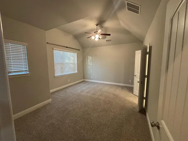 a view of a hallway with wooden floor and stairs