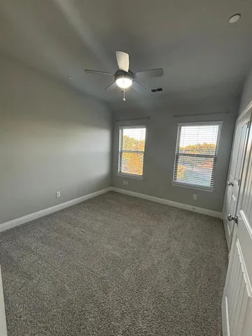 an empty room with windows and entrance