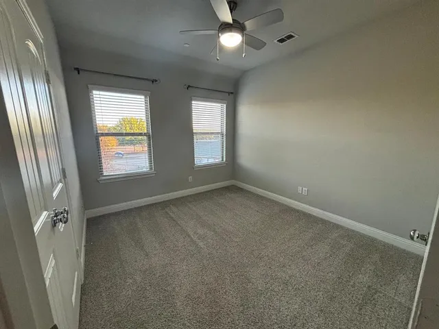 an empty room with windows and entrance