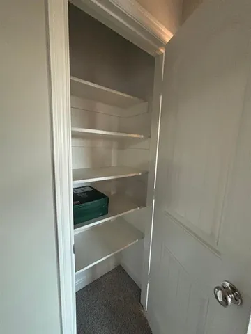 a view of an empty room and a window