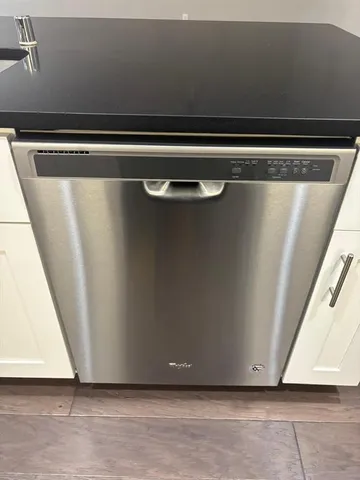 a kitchen with stainless steel appliances granite countertop a sink a refrigerator and a granite counter tops