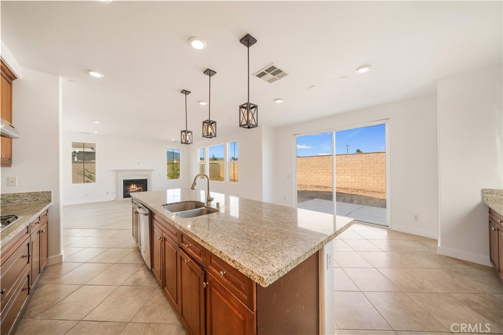 13296 Joliet Drive Rancho Cucamonga, CA 91739 - Photo 11 of 69 a kitchen with stainless steel appliances granite countertop a sink and a refrigerator