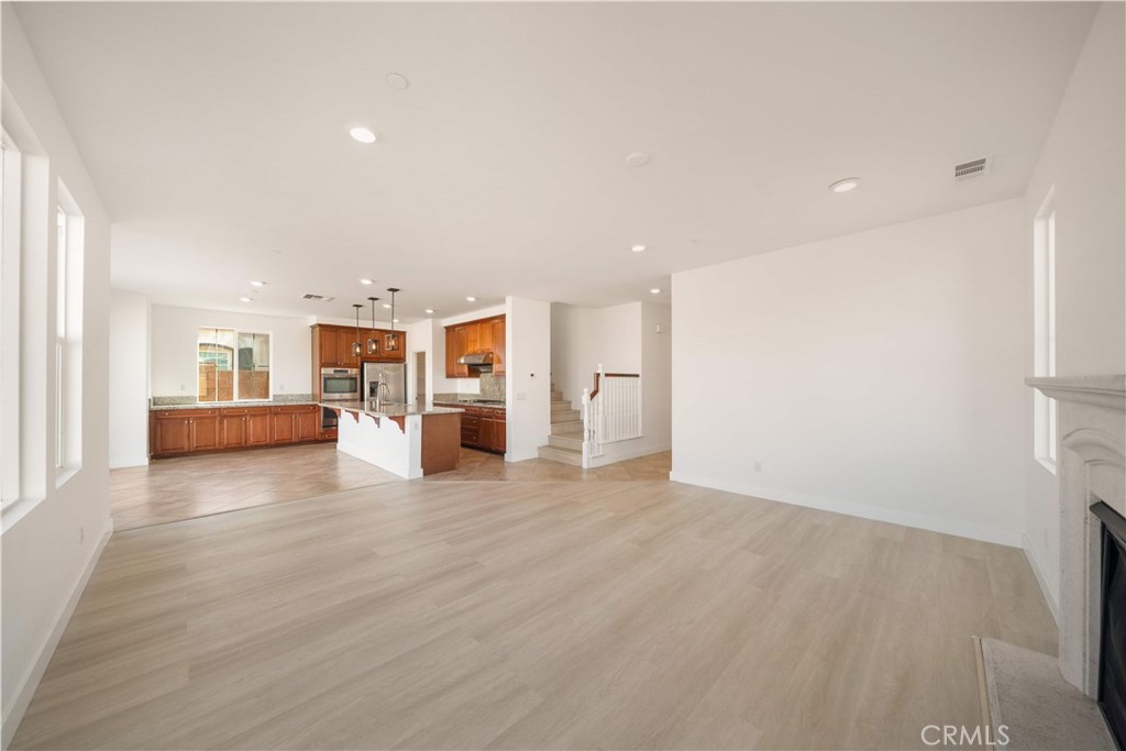 13296 Joliet Drive Rancho Cucamonga, CA 91739 - Photo 15 of 69 a view of a big room with wooden floor and windows