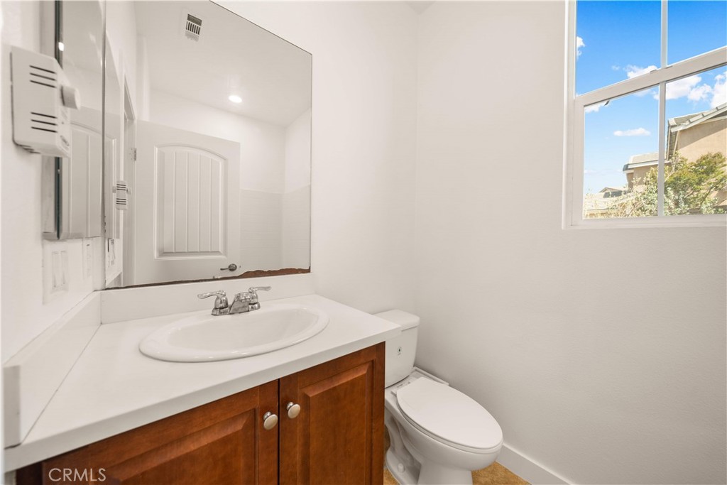 13296 Joliet Drive Rancho Cucamonga, CA 91739 - Photo 16 of 69 a bathroom with a sink a toilet and mirror